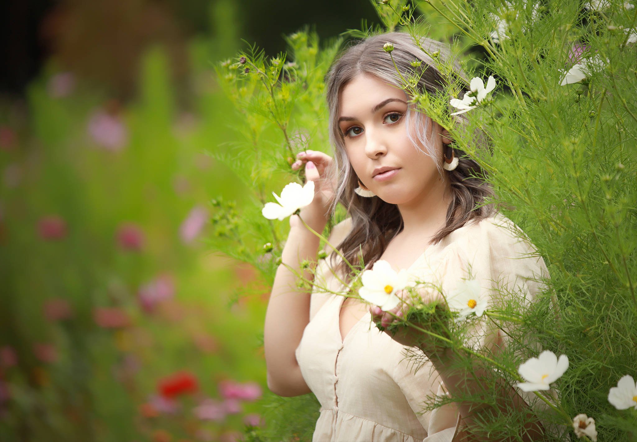 Senior portrait — standing between trees in golden light